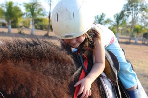 kid takes horseback riding lesson