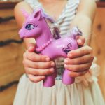 how to talk parents into letting you ride horses, girl holding pink pony toy