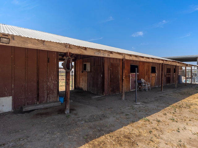 Norco Horse Town USA - house for sale with horse property, view of the rustic barn with 'country music lover' sign
